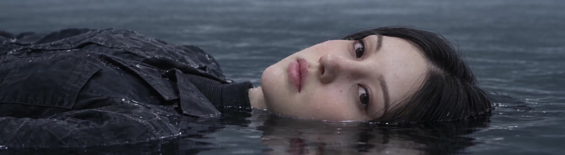 A face resting at the surface of the water